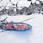 Icebreaker on Vistula river in winter, Plock, aerial view of Poland